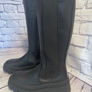 “a new day” Corene Black Boots with a rounded toe and sturdy sole